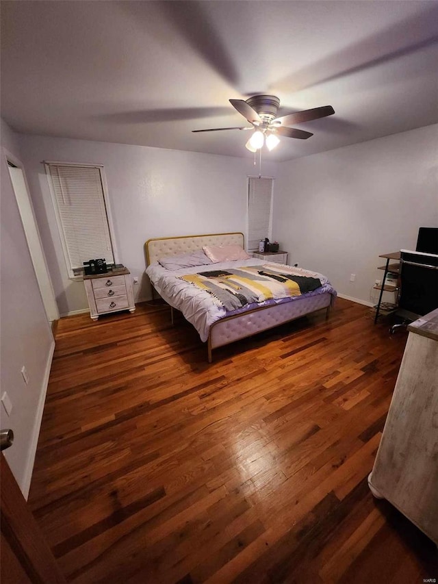 bedroom with ceiling fan and dark wood-type flooring