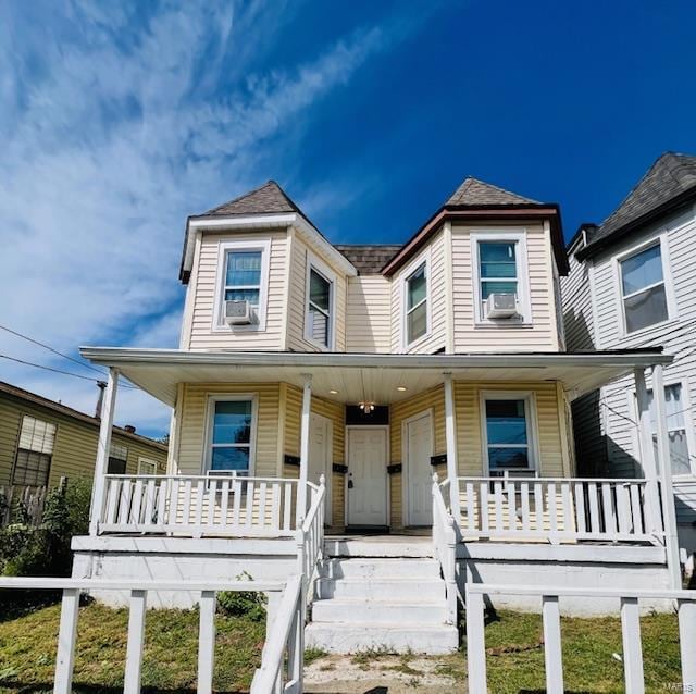 view of front of home with cooling unit and a porch