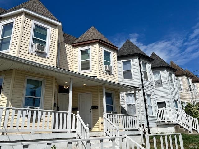 victorian home featuring cooling unit and covered porch