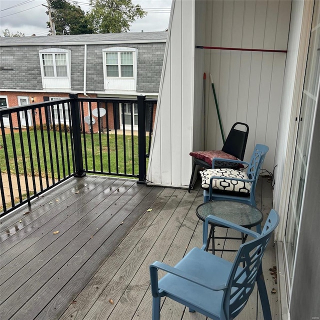 wooden terrace featuring a yard