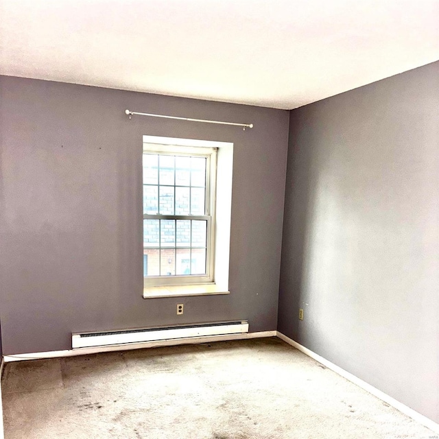 unfurnished room with carpet and a baseboard heating unit