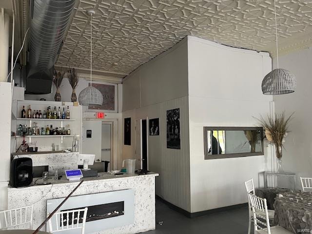 kitchen with pendant lighting and concrete floors