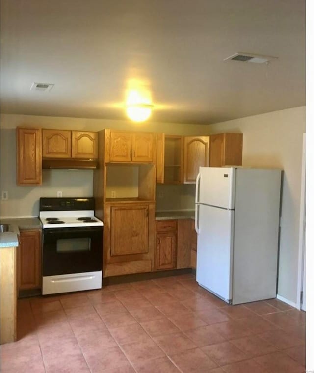 kitchen with white appliances and light tile patterned floors