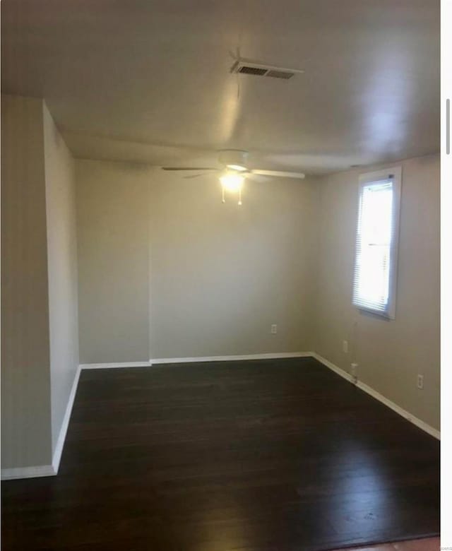 unfurnished room with ceiling fan and dark hardwood / wood-style floors