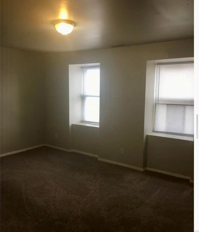 empty room with dark carpet