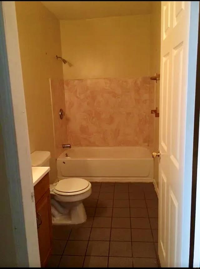 full bathroom featuring vanity, tiled shower / bath combo, toilet, and tile patterned flooring