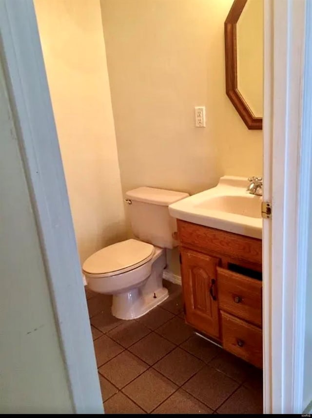 bathroom featuring vanity, tile patterned flooring, and toilet