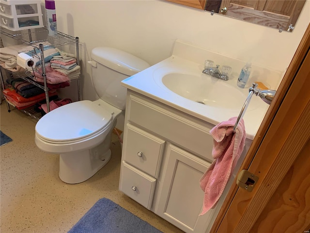 bathroom with vanity, backsplash, and toilet