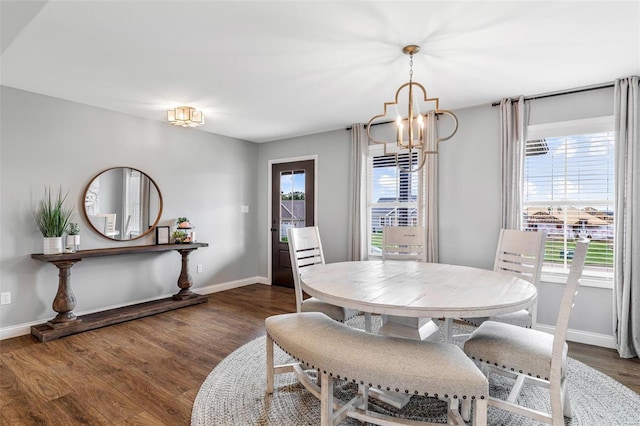 dining room with an inviting chandelier, dark wood-type flooring, and a wealth of natural light