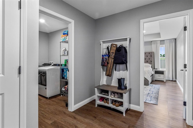 hall featuring washer and clothes dryer and dark wood-type flooring