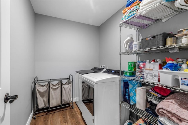 laundry room featuring wood-type flooring and washing machine and dryer