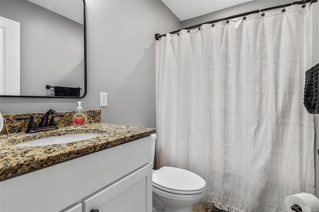 bathroom with a shower with shower curtain, vanity, and toilet