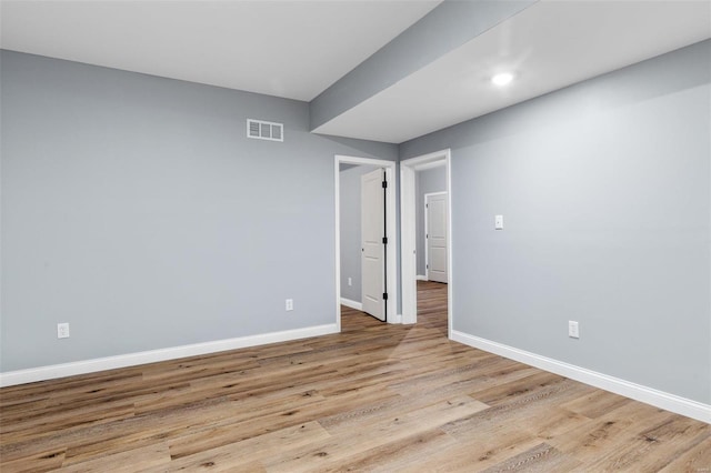 empty room with light hardwood / wood-style floors