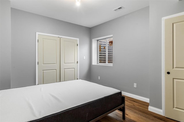 bedroom featuring hardwood / wood-style floors and a closet