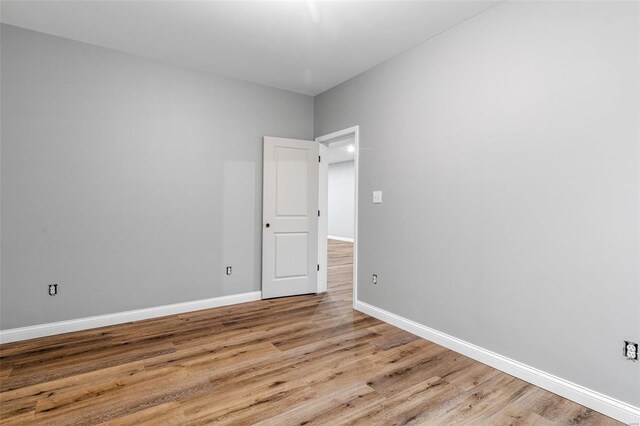 empty room with light hardwood / wood-style flooring