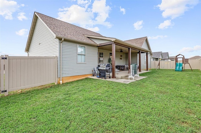 rear view of house featuring a patio and a lawn