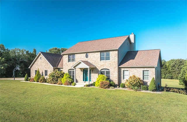 colonial inspired home featuring a front lawn