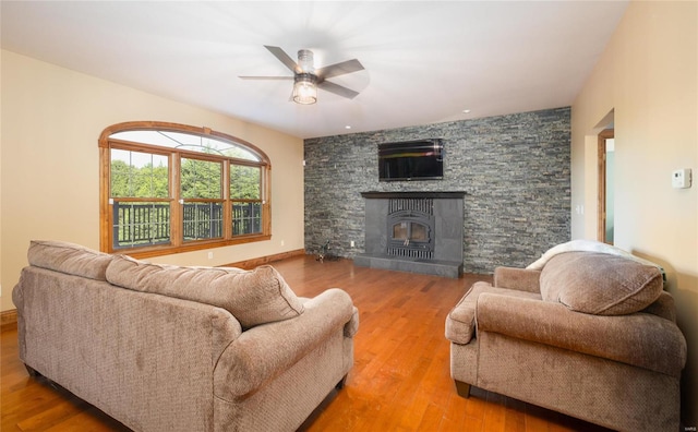 living room featuring hardwood / wood-style floors and ceiling fan