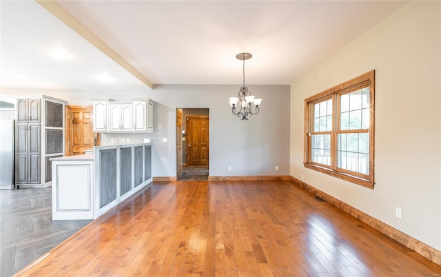 interior space featuring wood-type flooring and an inviting chandelier