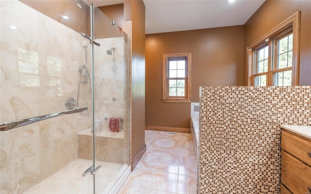 bathroom with backsplash, tile patterned flooring, vanity, and a shower with shower door