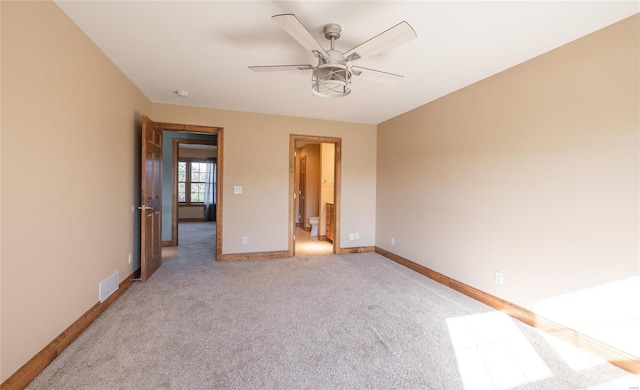 unfurnished bedroom with ceiling fan and light colored carpet