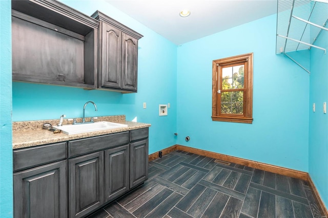 clothes washing area with washer hookup, cabinets, and sink