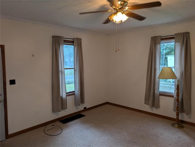 carpeted spare room with ornamental molding and ceiling fan