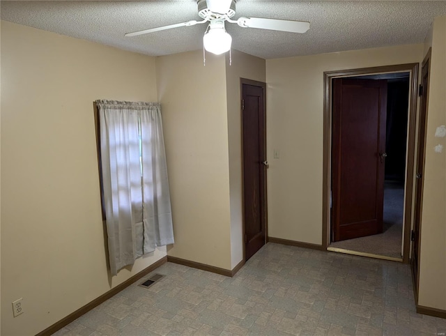 spare room featuring ceiling fan and a textured ceiling