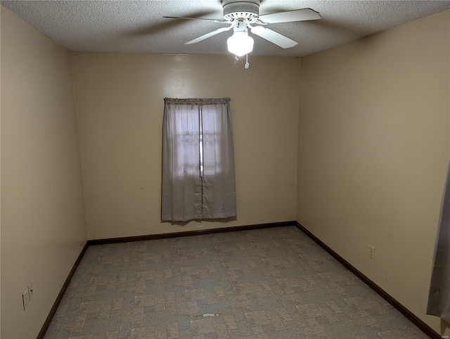 empty room featuring ceiling fan and a textured ceiling