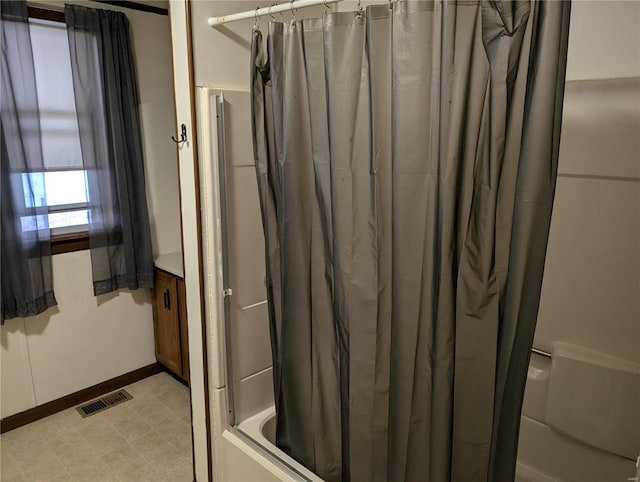 bathroom with shower / tub combo with curtain and vanity