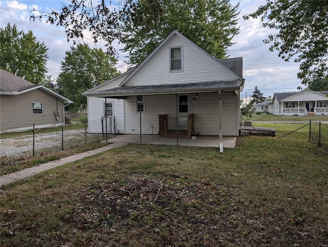 rear view of property with a yard and a patio