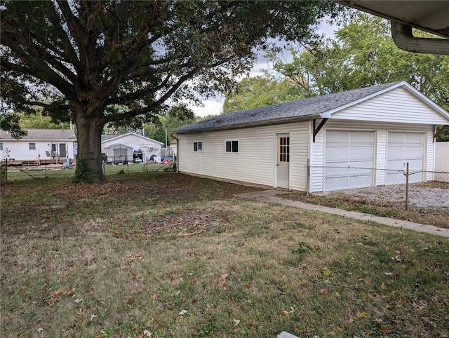 garage featuring a lawn