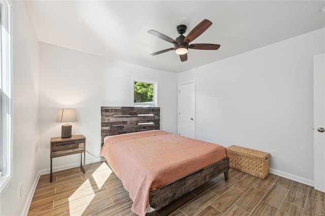 bedroom with ceiling fan and hardwood / wood-style floors