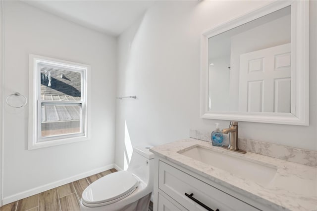 bathroom featuring wood-type flooring, vanity, and toilet