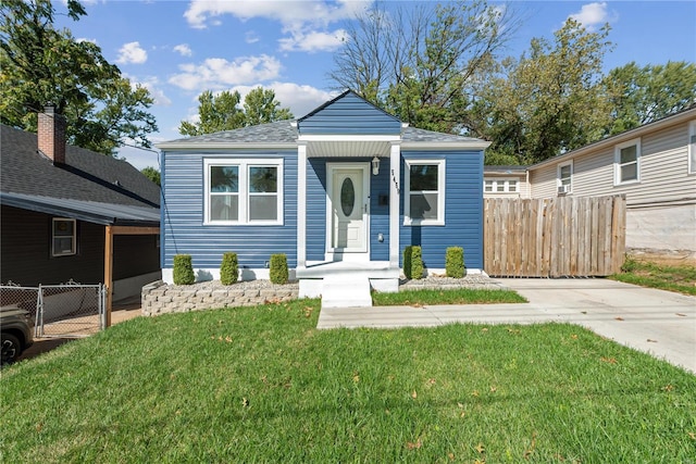 bungalow-style home with a carport and a front lawn