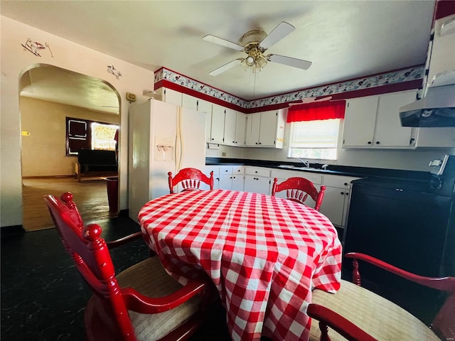 kitchen with ceiling fan, sink, extractor fan, white cabinetry, and white fridge with ice dispenser