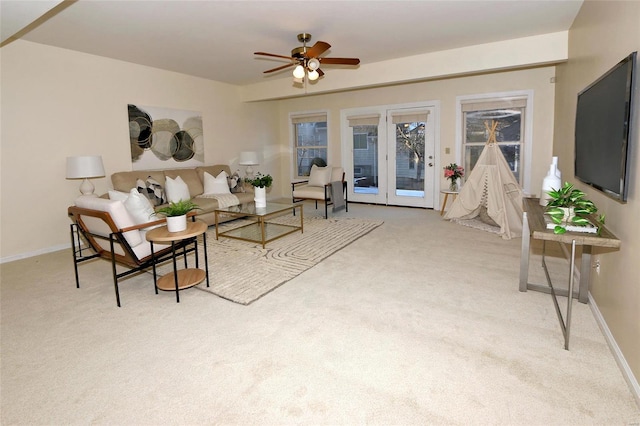 carpeted living room with ceiling fan