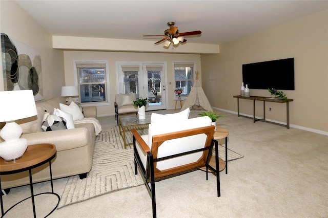 carpeted living room featuring ceiling fan