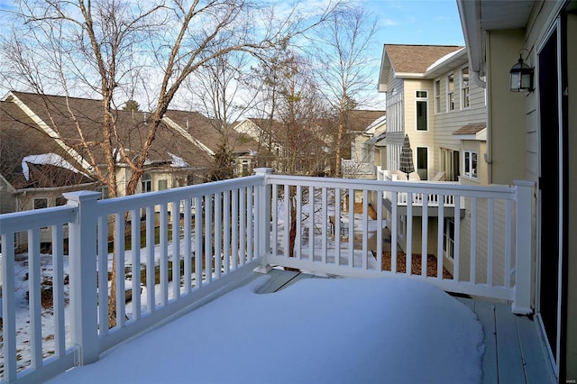 view of snow covered back of property