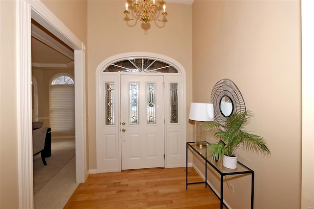 foyer featuring an inviting chandelier and light hardwood / wood-style flooring