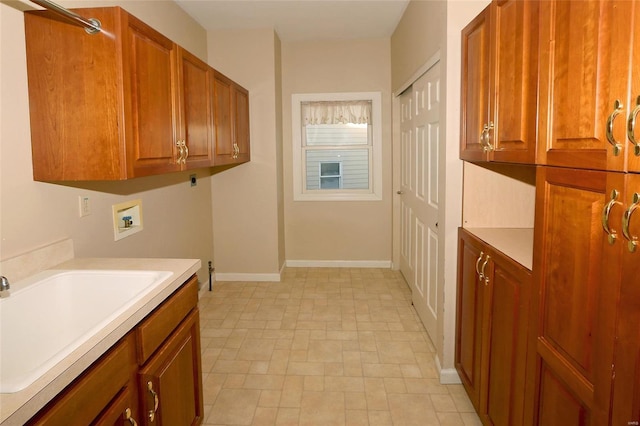 washroom with cabinets, washer hookup, sink, and electric dryer hookup