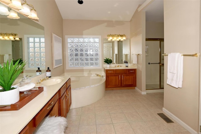 bathroom with tile patterned floors, independent shower and bath, and vanity