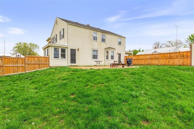 rear view of property with a yard