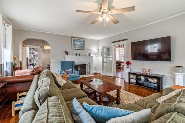 living room featuring ornamental molding, hardwood / wood-style floors, ceiling fan, and a wealth of natural light