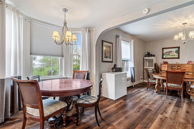 dining room with a notable chandelier and dark hardwood / wood-style floors