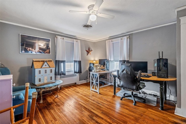 office space with ornamental molding, wood-type flooring, ceiling fan, and a textured ceiling