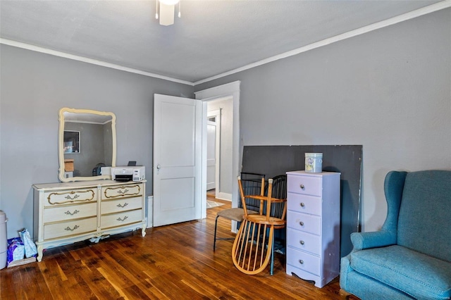 sitting room with crown molding and dark hardwood / wood-style flooring