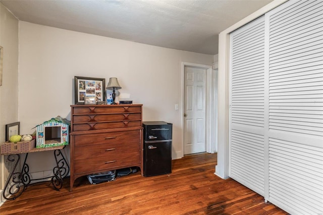 misc room featuring a textured ceiling and dark hardwood / wood-style flooring