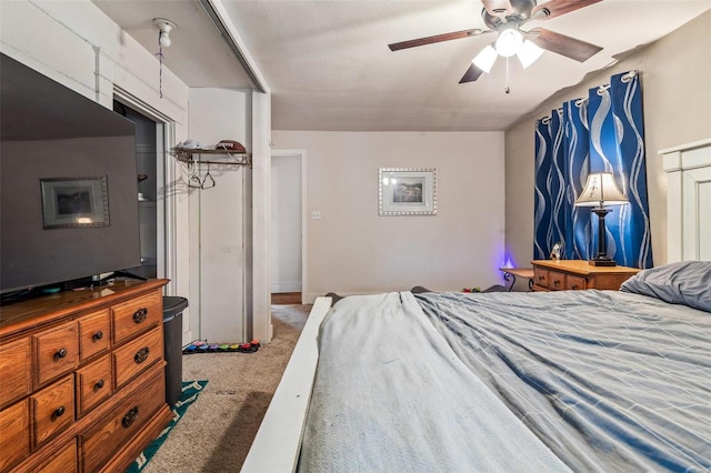 bedroom featuring carpet, ceiling fan, and a textured ceiling