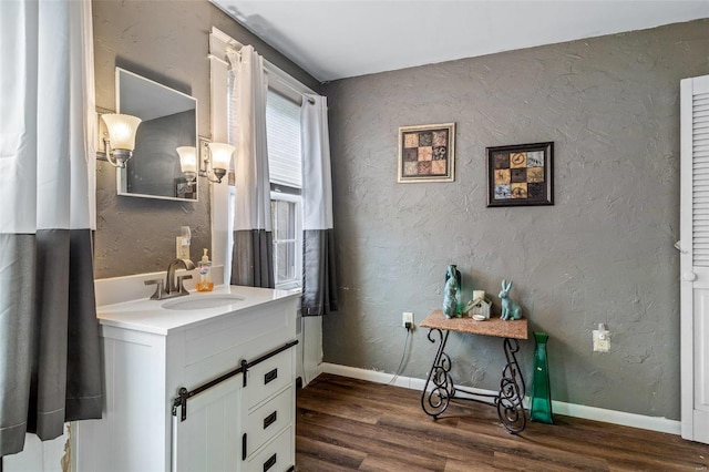 bathroom featuring hardwood / wood-style flooring and vanity